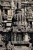 Prambanan - Candi Lara Jonggrang, miniature shrines surmounted by small fluted stupa with panels with musicians and dancers decorating the top of the balustrade 